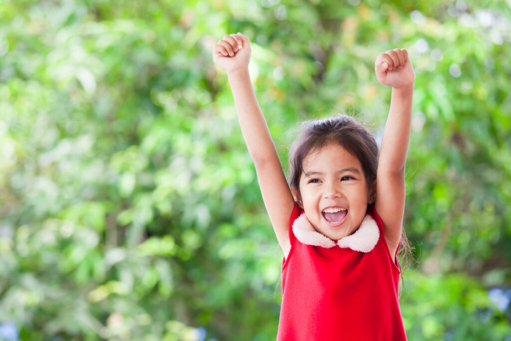 Girl celebrating her success at behaving well at a holiday Christmas gathering