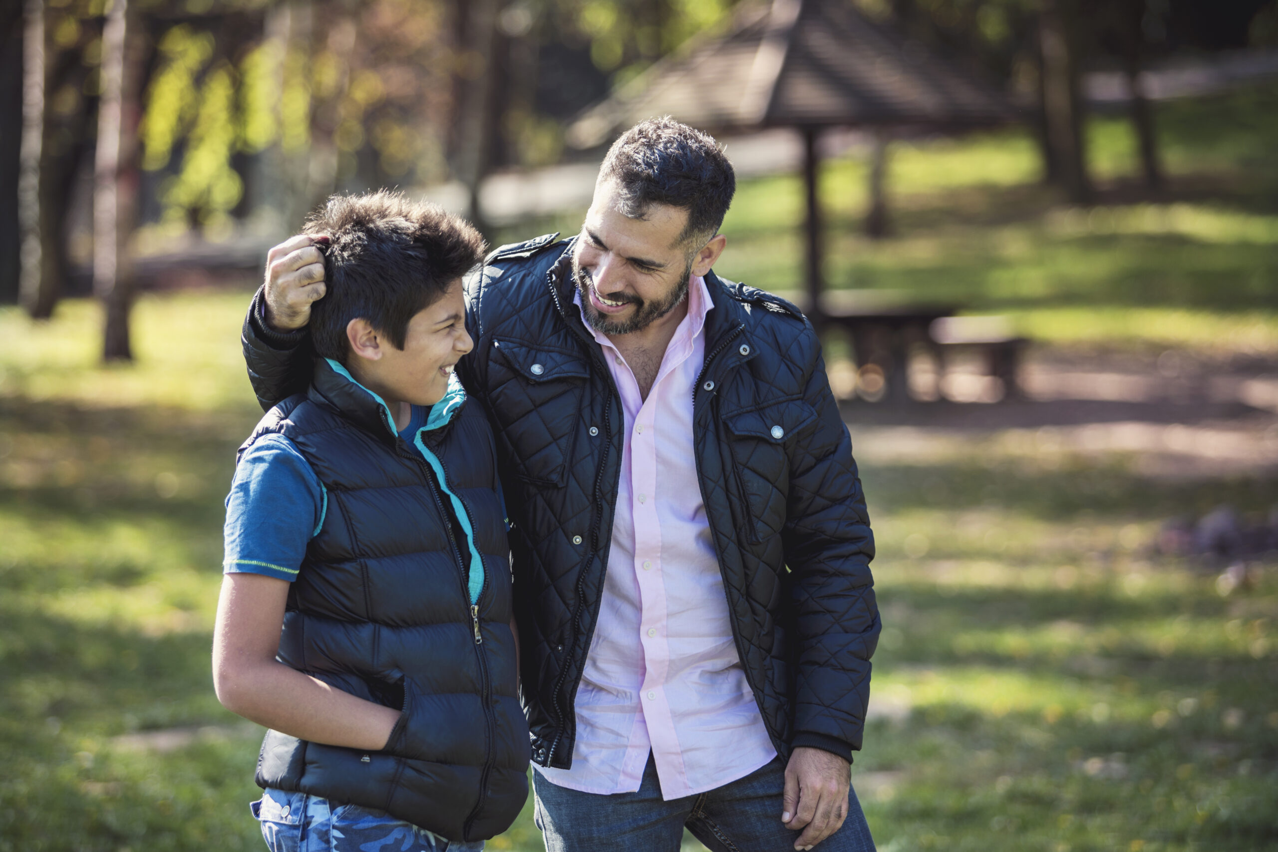 Trash, Truth, Treasure: How to React When Someone Says Hurtful Things 5 Dad and tween son walking together outdoors. Dad's arm is around son.