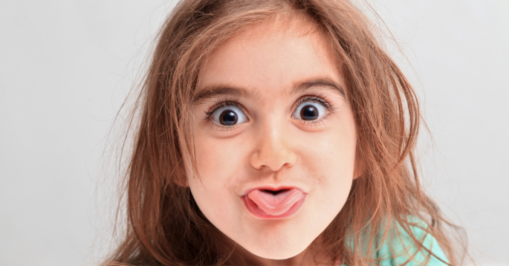 child laughs when in trouble, being silly