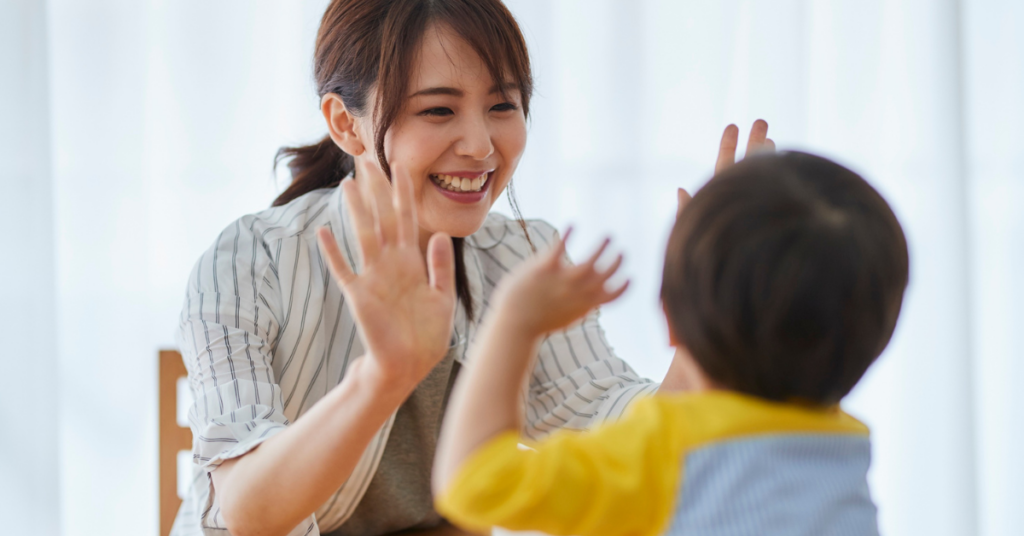 parent and child celebrating (after coaching: child laughing when in trouble)
