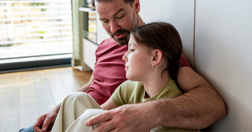 Dad on floor with daughter, helping without harshness