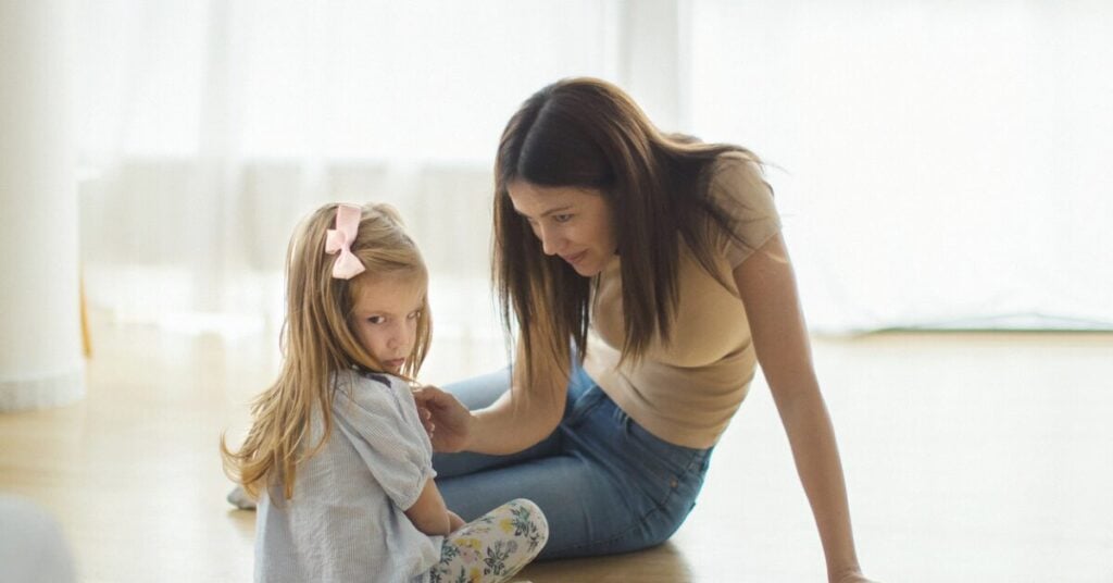break habits of harshness with slow low & listen. mom on the ground with her child, comforting