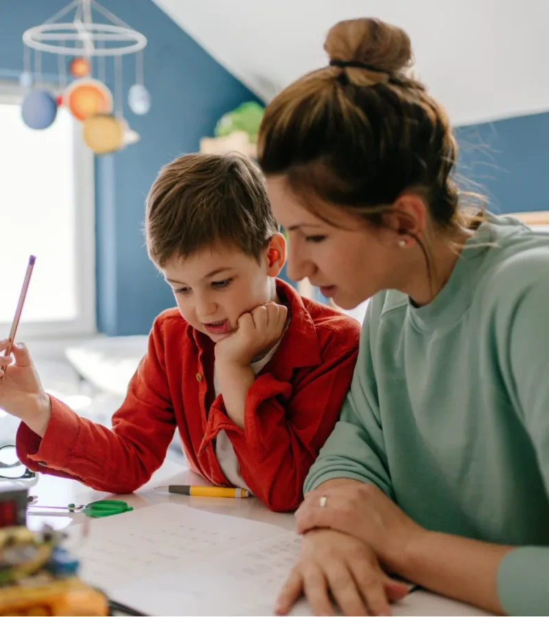 Mom-sitting-with-her-son-at-desk